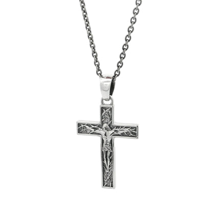 Silver cross pendant necklace on a white background