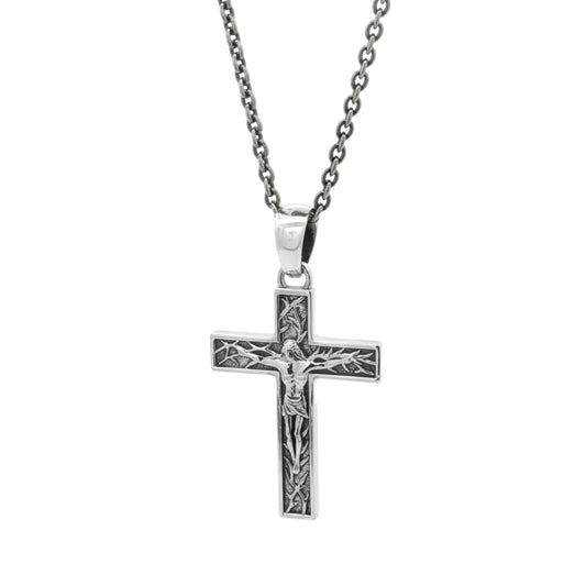 Silver cross pendant necklace on a white background