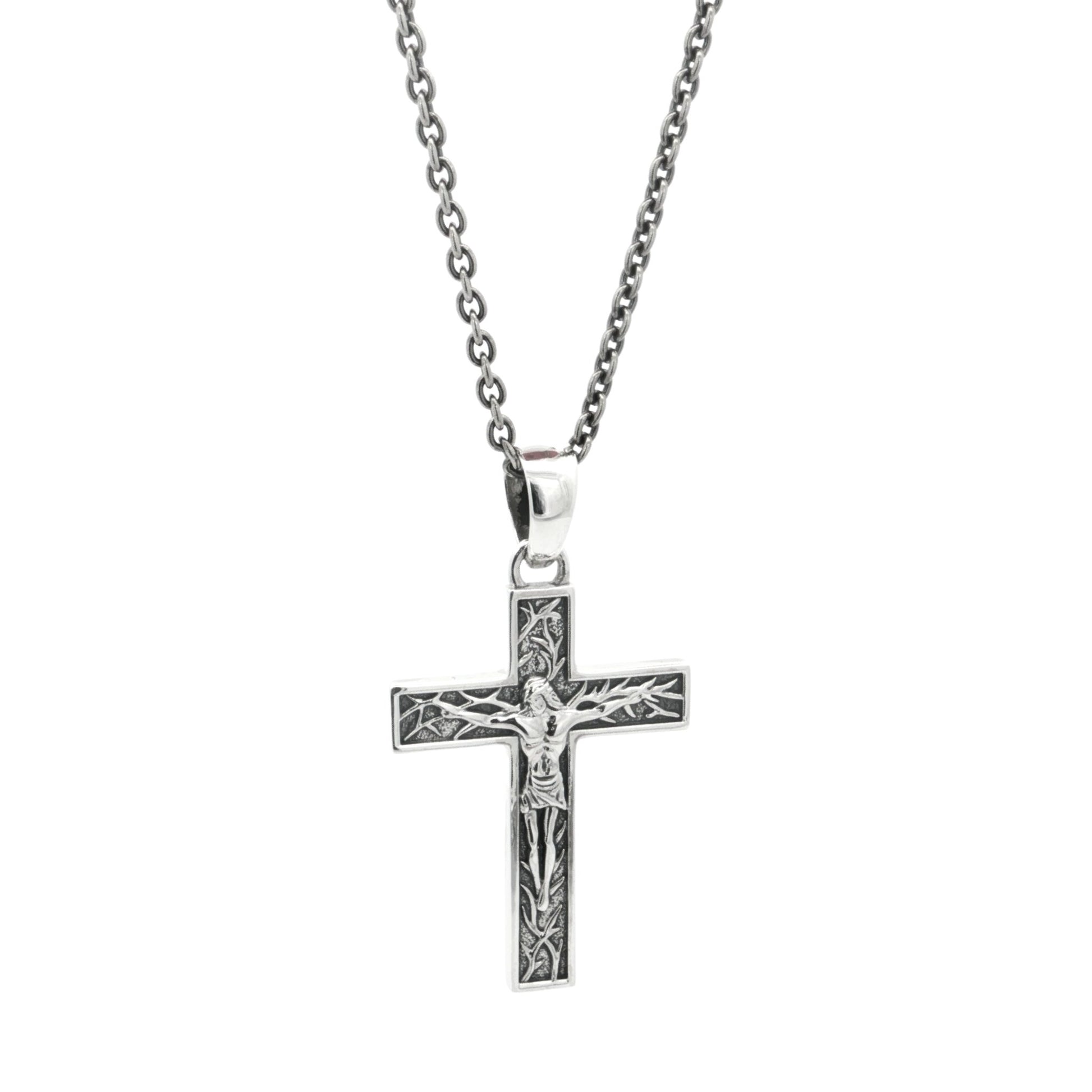 Silver crucifix cross pendant necklace on a white background