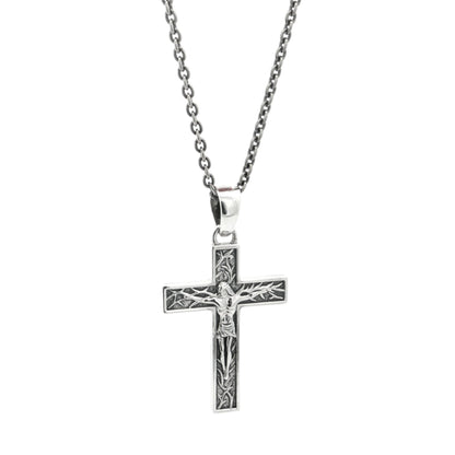 Silver crucifix cross pendant necklace on a white background